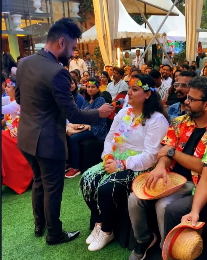 Emcee engaging the audience at an outdoor team event
