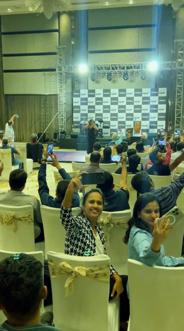Audience filming a live stage performance